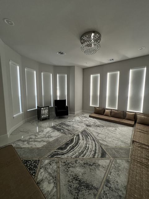 Roller shades in a bay-window living room