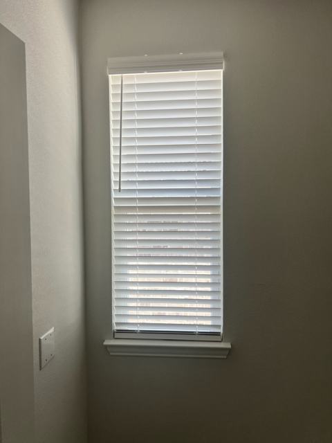 Wood blinds on a tall window
