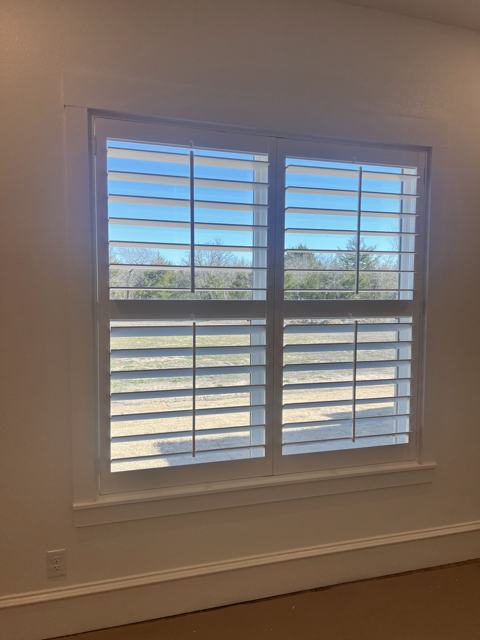 White plantation shutters on a double window